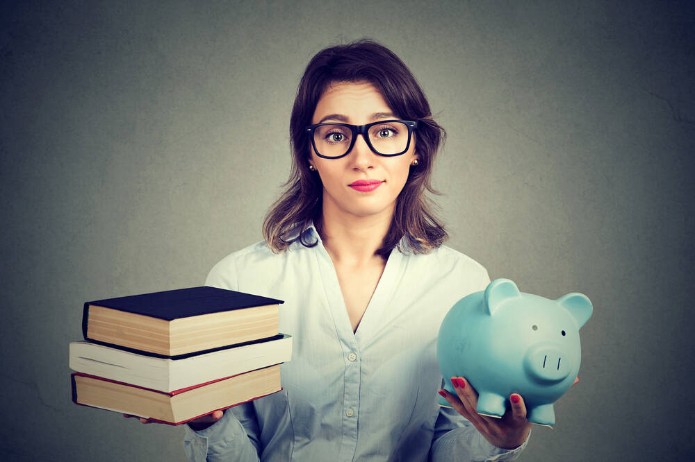 student,loan,concept.,young,woman,with,stack,pile,of,books