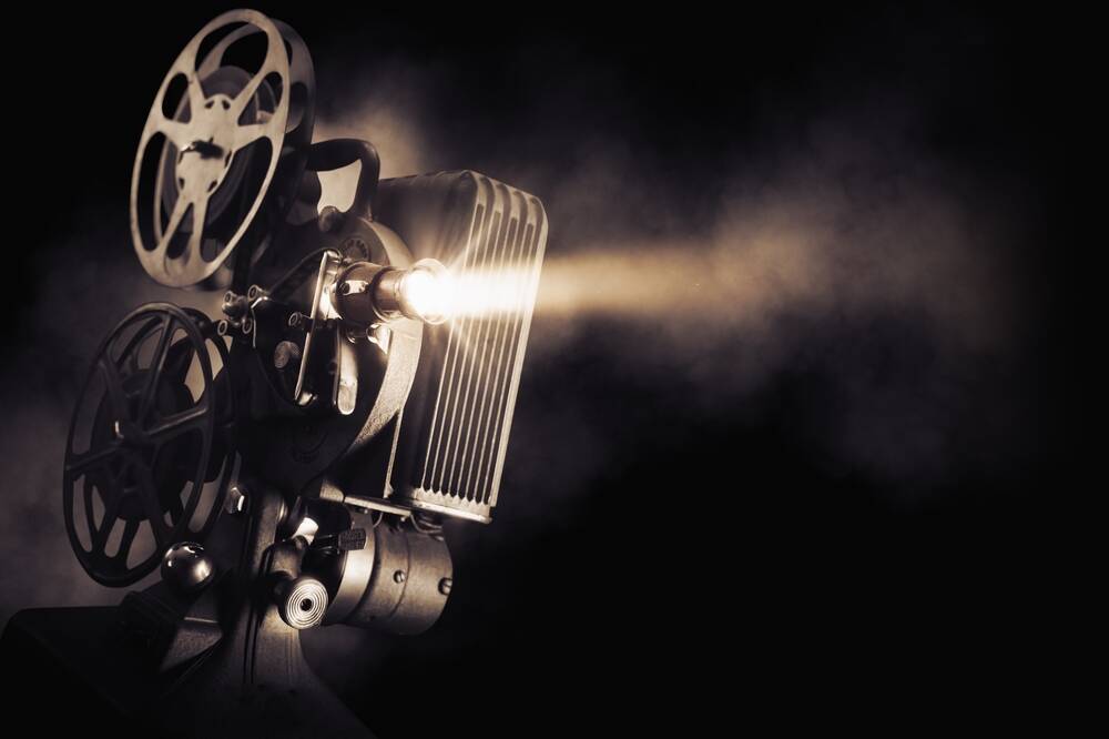movie,projector,on,a,dark,background,with,light,beam,/