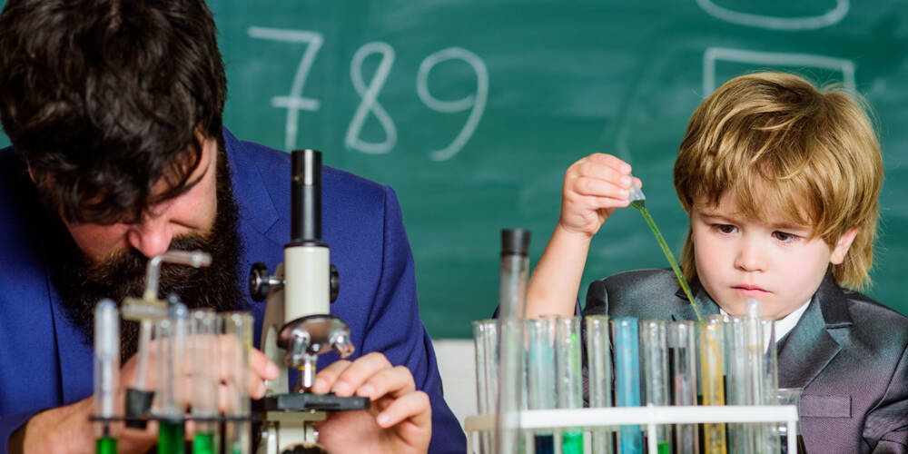 small,boy,with,teacher,man.,flask,in,scientist,hand,with
