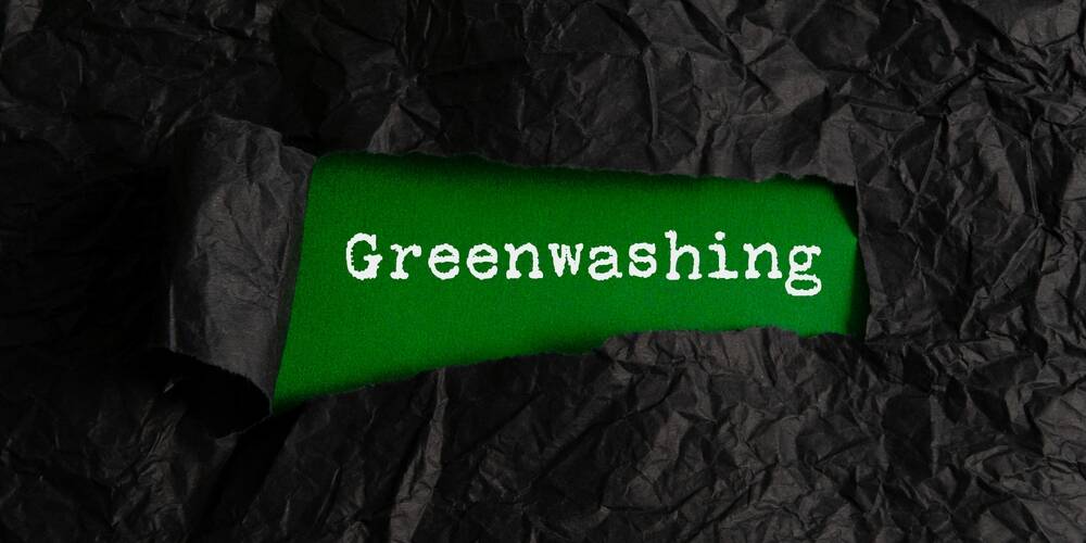 black,crumpled,paper,torn,off,reveals,green,paper,with,the