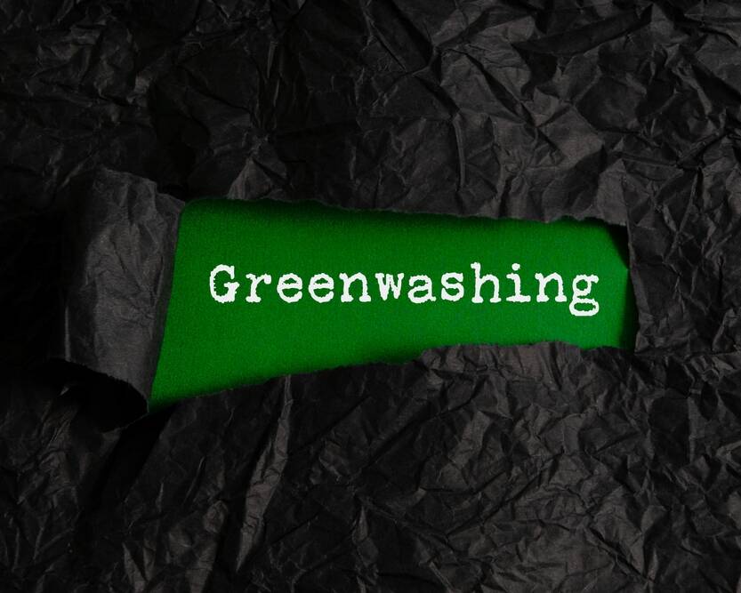 black,crumpled,paper,torn,off,reveals,green,paper,with,the