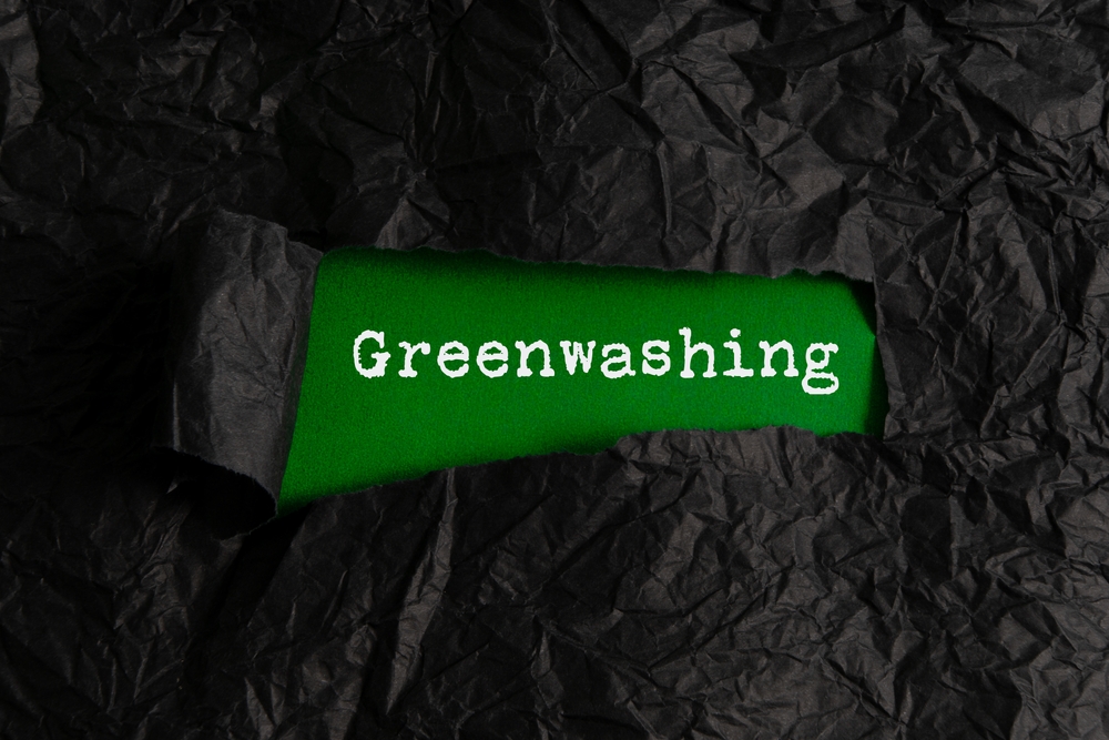 black,crumpled,paper,torn,off,reveals,green,paper,with,the