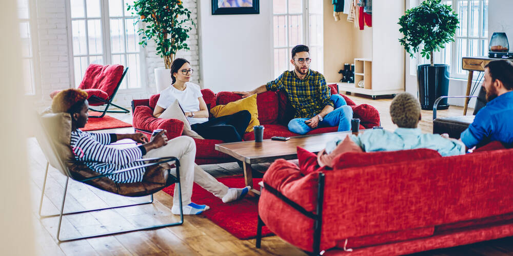 youthful,people,20s,sitting,at,couch,in,living,room,having