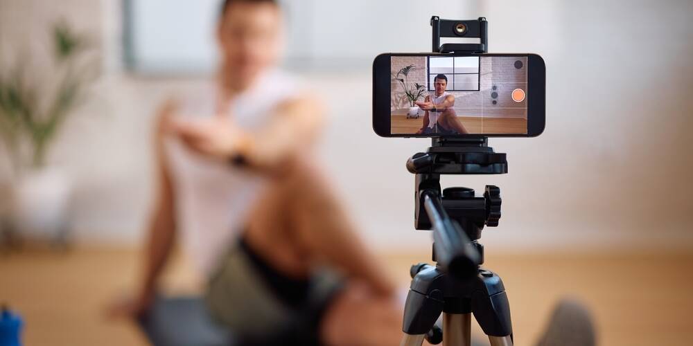 close,up,of,personal,trainer,broadcasting,online,his,exercise,class