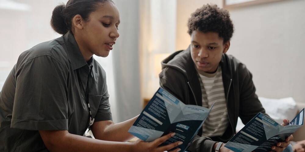 black,female,young,adult,social,worker,explaining,information,to,black