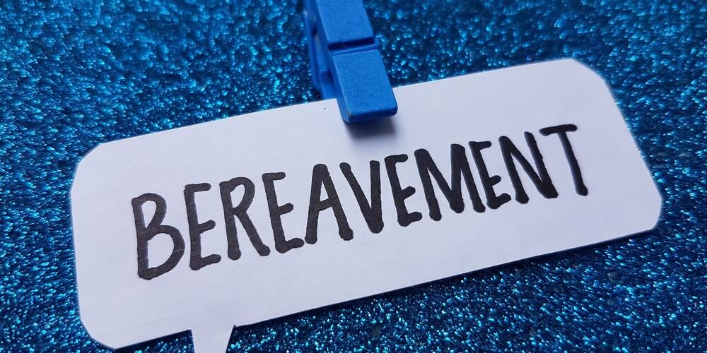 bereavement,writting,on,blue,background.